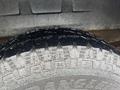 Close-up of a rugged tire tread with deep grooves and patterns designed for enhanced traction on a 2006 Ford Econoline