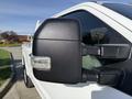 Close-up of the side mirror on a 2021 Ford F-250 SD showcasing a black casing and an integrated turn signal light