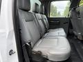 Interior view of the back seat of a 2015 Ford F-350 SD featuring grey leather upholstery and three seats with armrests