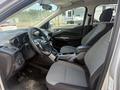 Interior of a 2014 Ford Escape featuring two front seats with a center console and dashboard visible
