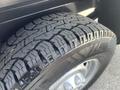 Close-up of a tire on a 2012 RAM 2500 showcasing a rugged tread pattern and aluminum wheel rim