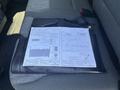 A 2023 Ford F-350 SD owner's manual placed on a black carrying case with various instructions and diagrams