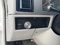 Dashboard controls of a 1994 GMC Vandura 3500 featuring a round light switch and instrument panel with speedometer and other gauges