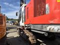 A 2018 Sandvik Ranger DX800 drilling rig with a white and red exterior and continuous tracks visible on its base