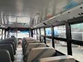 Interior view of a 2007 Freightliner B2 school bus featuring gray seats arranged in rows with large windows allowing natural light to enter the cabin