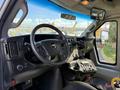 Interior view of a 2017 Chevrolet Express showing the steering wheel dashboard controls and gear shift