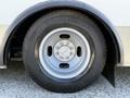 Close-up view of a tire mounted on a wheel rim of a 2014 Chevrolet Express showcasing the tread and design of the wheel