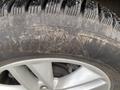 Close-up of a tire on a 2017 Ford Edge showing worn tread and the brand name clearly visible on the sidewall
