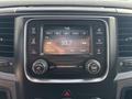 Interior dashboard display of a 2013 RAM 5500 showing radio settings and controls with a digital screen displaying the time and radio station