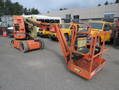 A 2009 JLG E300AJP articulated boom lift with an orange structure and a platform extending upward for elevated work tasks