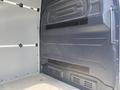 Interior view of a 2025 Mercedes-Benz Sprinter showing the cargo area with gray walls and floor and features for securing loads