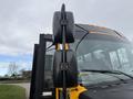 A 2022 Freightliner B2 school bus with prominent black side mirrors and a bright yellow exterior visible in the foreground