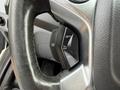 Close-up of a 2017 Ford Transit steering wheel control with buttons for setting cruise control and adjustments