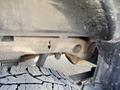 2014 GMC Sierra 1500 showcasing part of its undercarriage with visible rust and a close-up of the rear tire tread