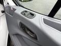 Interior door handle of a 2019 Ford Transit with a gray panel design and a window control switch