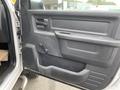 The interior door panel of a 2011 Dodge Ram 5500 featuring controls for windows and locks along with a textured grip area