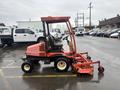 A 2010 Kubota F3680 mower with a red and black color scheme features a cabin and mower deck attached at the front