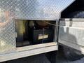 A large battery is housed inside a compartment of a 1994 Volvo FE 42 with metal diamond plate detailing