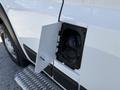 A close-up of the fuel filler door on a 2021 RAM Promaster revealing the fuel cap and attached wiring inside