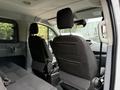Interior view of a 2017 Ford Transit showing two front seats with headrests and a partition behind them