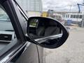 A black 2014 Honda Odyssey side mirror reflecting the interior seats and dashboard visible through the window