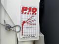 A load chart displayed on a metal surface showing weight capacities in pounds for a P10 Series crane