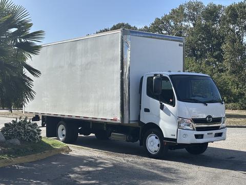 A 2018 Hino 195 box truck with a white cargo area and a front cab featuring a prominent grille and headlights
