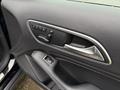 Interior door handle and control panel of a 2016 Mercedes-Benz GLA-250 featuring seat adjustment buttons and a textured black finish