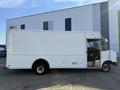 A 2012 Ford Econoline box truck with a white exterior is parked, showing its side view and front cabin without any visible branding or additional markings