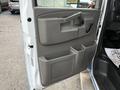 The image shows the interior driver's side door of a 2019 Chevrolet Express featuring a gray panel with a handle and storage compartments