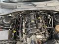 A 2019 Dodge Charger engine compartment featuring the V8 engine with various components including hoses and electrical connections