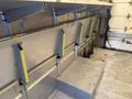 Interior of a 2012 Ford Econoline with metal shelving and support brackets visible on the walls