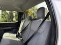 Interior view of the back seat of a 2021 Ford F-150 with gray fabric upholstery and seatbelts visible on the seats