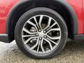 The wheel of a 2016 Mitsubishi Outlander featuring a multi-spoke alloy rim and Yokohama tire with visible tread pattern