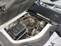 Engine compartment of a 2010 Suzuki Carry showing the engine and various components mounted within the space