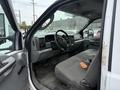 Interior of a 2004 Ford F-350 SD showing the driver's seat steering wheel dashboard and gear shift