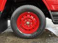 A red wheel of a 2001 Toyota Dyna featuring a black tire with the brand name on the sidewall