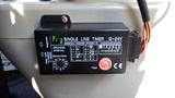 Control panel for a greasing system with a timer and various settings including a test button and indicators