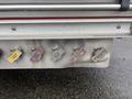 A close-up view of a 2006 E-One Typhoon fire truck's control panel featuring various colored valves and connectors for fire hose connections