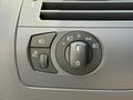 Close-up of the control panel in a 2004 BMW 6-Series featuring dials for headlights and fog lights with various settings