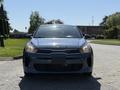 A blue 2018 Kia Rio5 facing front with a sleek design featuring a modern grille and bright headlights