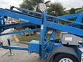 A blue 2016 Genie TZ-34/20 aerial lift with an extended boom and platform for reaching elevated areas