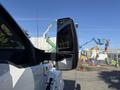 A 2017 Ford F-650 Super Duty truck with a large side mirror showing the vehicle's sturdy build and design