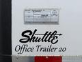 A black logo featuring the word Shuttle with an arrow integrated into the design followed by the text Office Trailer 20