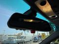 Rearview mirror of a 2004 BMW 6-Series with interior lights and a red indicator light