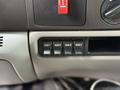 Four auxiliary switch buttons labeled AUX 1 AUX 2 AUX 3 AUX 4 on the dashboard of a 2007 Ford F-550