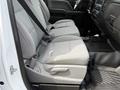 Side view of the interior back seat of a 2018 Chevrolet Silverado 1500 featuring gray fabric upholstery and seatbelts