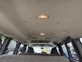 Interior view of a 2004 Chevrolet Express showing the ceiling with lights and upholstered material
