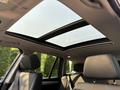 Interior view of a 2013 BMW X3 featuring a dual panoramic sunroof and black leather seats