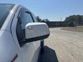 A white 2017 Chevrolet Colorado showing the side mirror and part of the vehicle's door